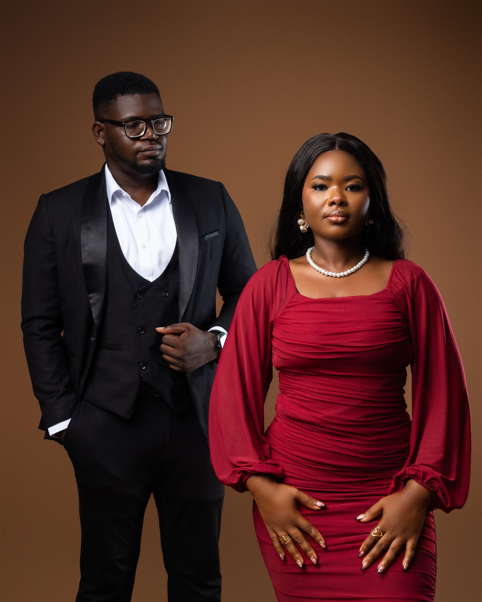 Benard and Phidelia in a formal wine and black portrait.