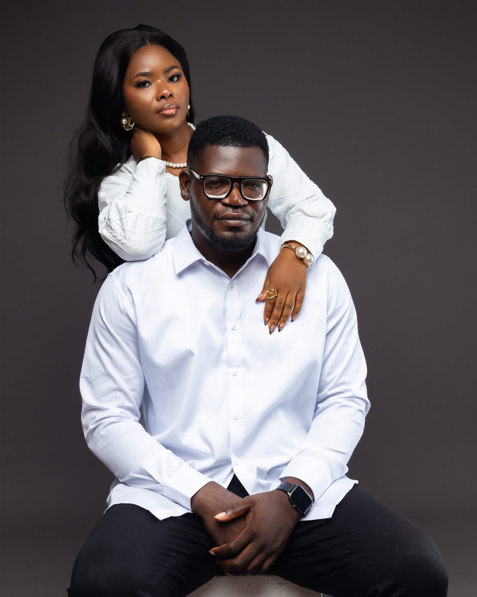 Benard and Phidelia dressed in white in a formal portrait.
