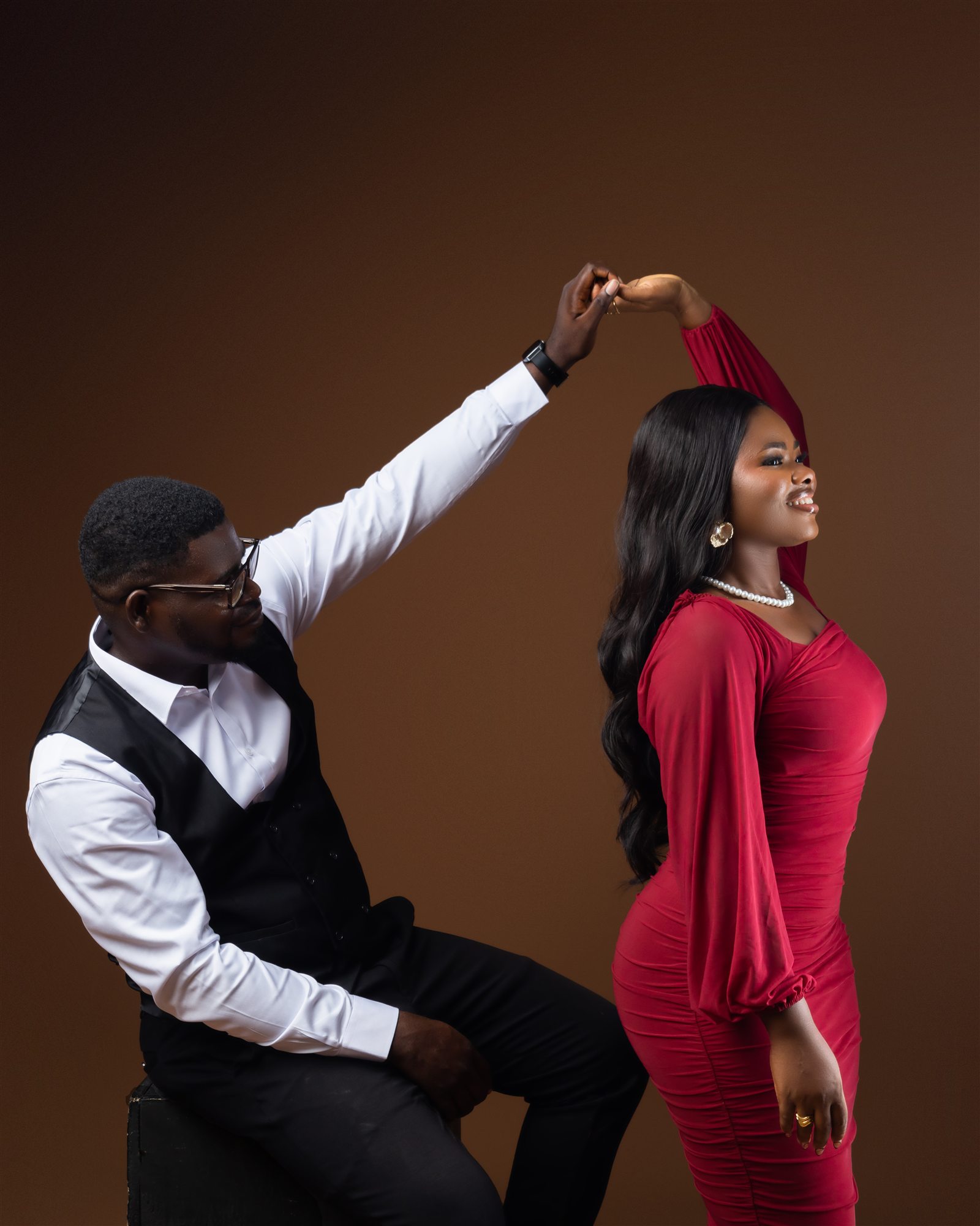 Benard and Phidelia sharing a playful dance moment.